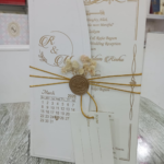 Minimalist White & Gold Wedding Card with Floral Seal - Image 2